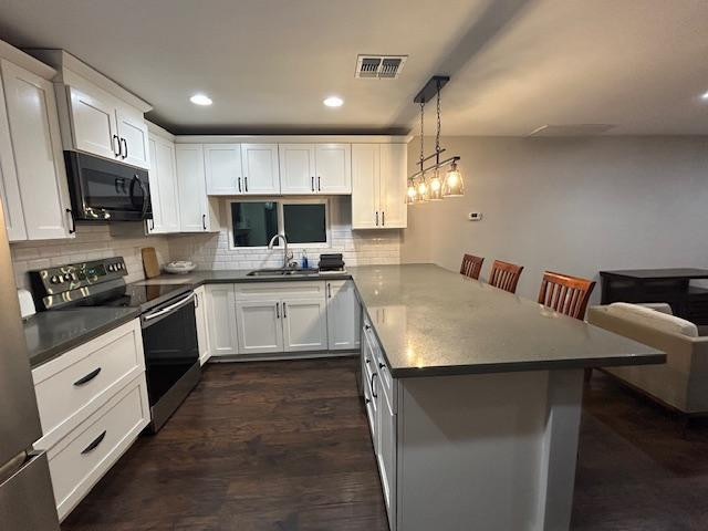 1117 West 9th Street Tempe, AZ 85281 - Photo 6 of 22 a kitchen with a stove a sink and a microwave