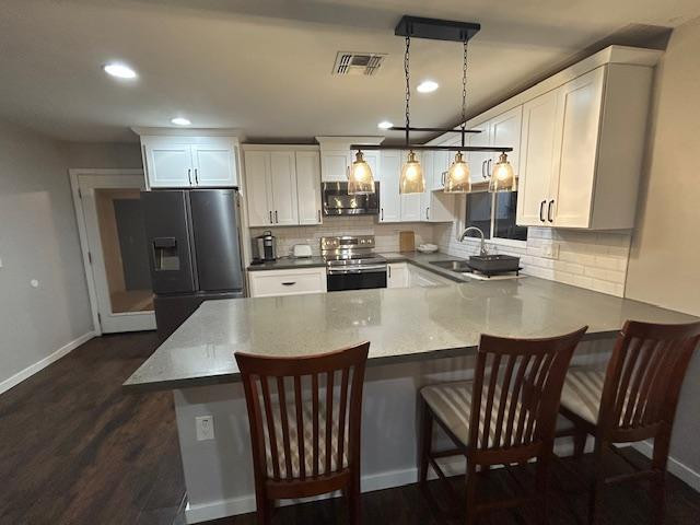 1117 West 9th Street Tempe, AZ 85281 - Photo 10 of 22 a kitchen with stainless steel appliances kitchen island granite countertop a dining table chairs and a refrigerator