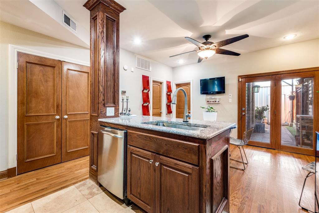 447 Josephine Street Dallas, TX 75246 - Photo 12 of 26 a kitchen with stainless steel appliances granite countertop a refrigerator a sink and dishwasher