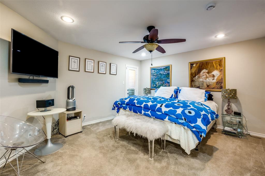 447 Josephine Street Dallas, TX 75246 - Photo 18 of 26 a bedroom with furniture and a flat screen tv