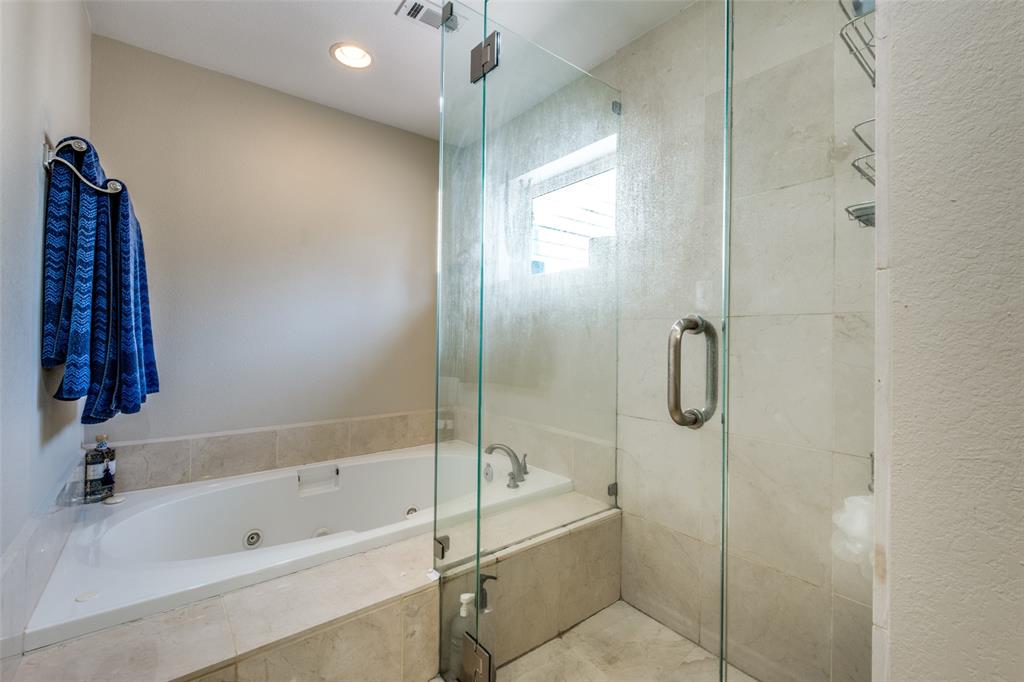 447 Josephine Street Dallas, TX 75246 - Photo 20 of 26 a bathroom with a bathtub and a shower