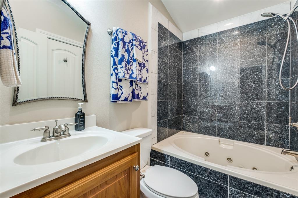 447 Josephine Street Dallas, TX 75246 - Photo 22 of 26 a bathroom with a sink toilet and shower