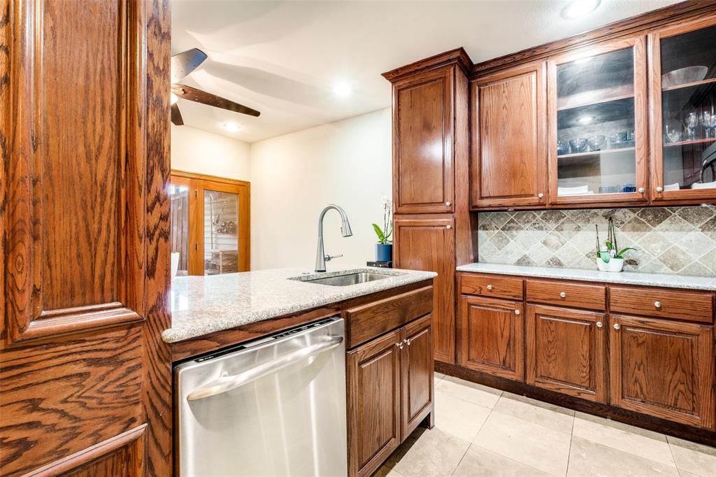 447 Josephine Street Dallas, TX 75246 - Photo 10 of 26 a kitchen with stainless steel appliances granite countertop a sink and a refrigerator