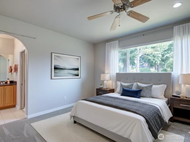 a bedroom with a large bed and a chandelier