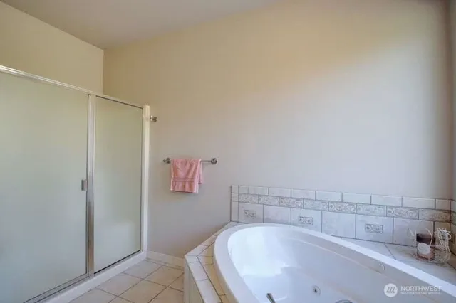 a bathroom with a tub and shower