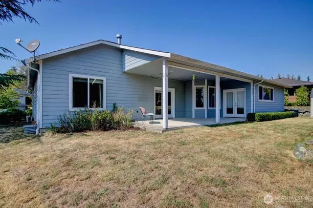 a backyard of a house with yard and outdoor seating