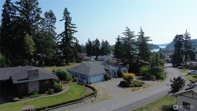 an aerial view of a house with garden space and street view