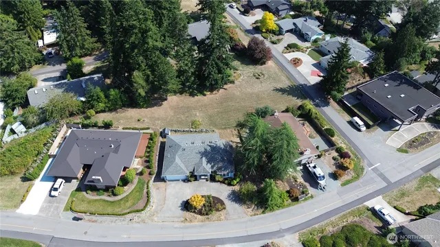 an aerial view of a house with garden space and street view