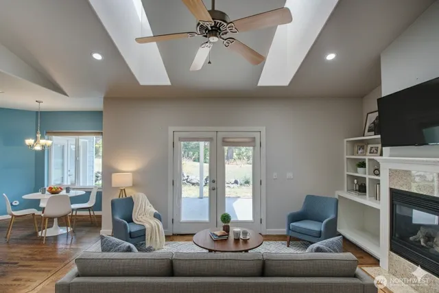 a living room with furniture a fireplace and a flat screen tv