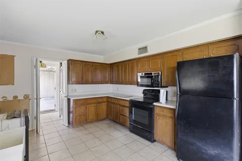 a kitchen with a refrigerator sink and microwave