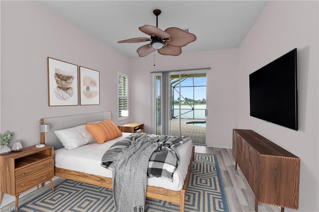 2880 Orange Grove Trail Naples, FL 34120 - Photo 13 of 42 a bedroom with a bed and a flat screen tv