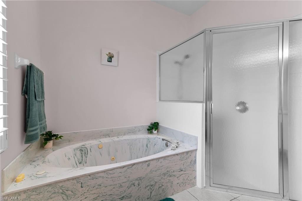 2880 Orange Grove Trail Naples, FL 34120 - Photo 15 of 42 a bath tub sitting next to a bathroom sink