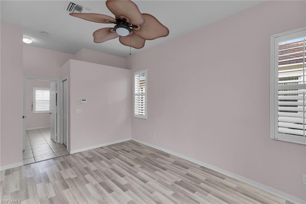 2880 Orange Grove Trail Naples, FL 34120 - Photo 17 of 42 Spare room featuring light wood finished floors and a ceiling fan