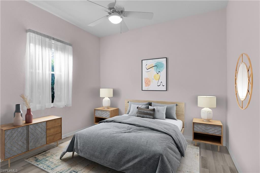 2880 Orange Grove Trail Naples, FL 34120 - Photo 23 of 42 a bedroom with a bed and a chandelier