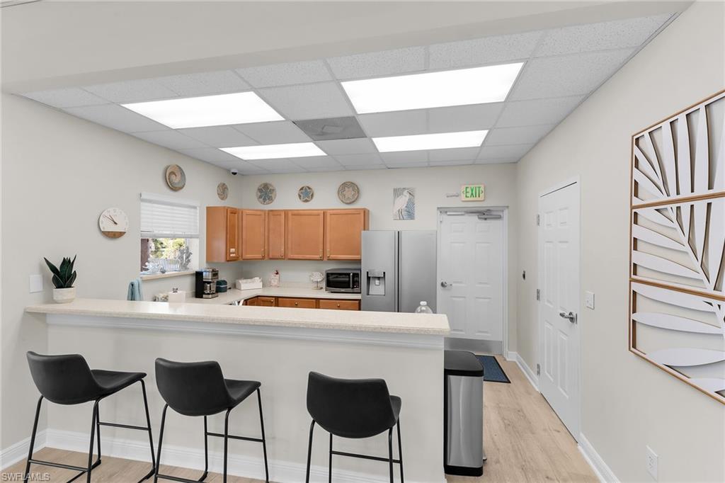 2880 Orange Grove Trail Naples, FL 34120 - Photo 31 of 42 a kitchen with stainless steel appliances a sink and a refrigerator