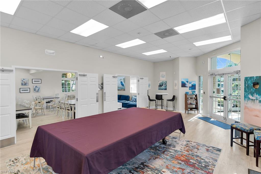 2880 Orange Grove Trail Naples, FL 34120 - Photo 35 of 42 a living room with furniture a table and kitchen view