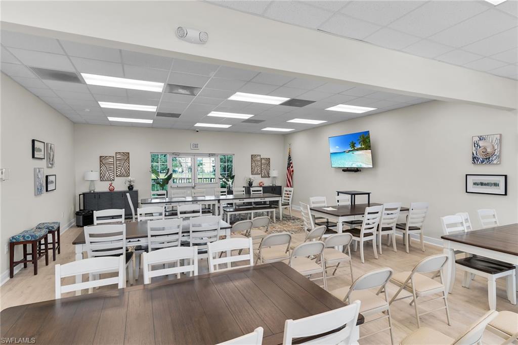 2880 Orange Grove Trail Naples, FL 34120 - Photo 36 of 42 a living room with lots of furniture and view of kitchen