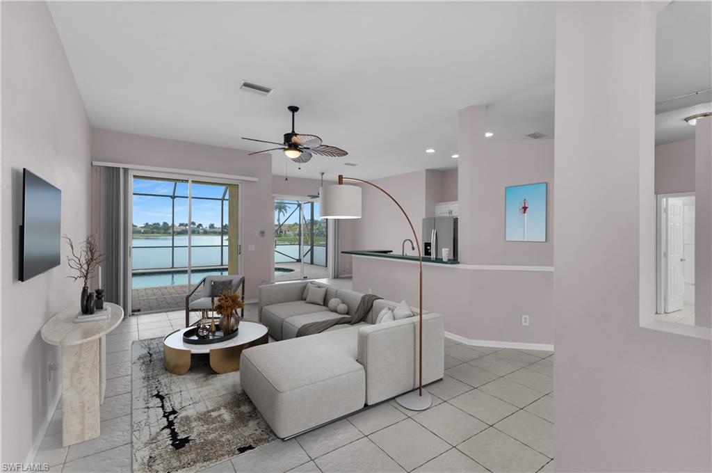 2880 Orange Grove Trail Naples, FL 34120 - Photo 5 of 42 a living room with furniture and floor to ceiling windows
