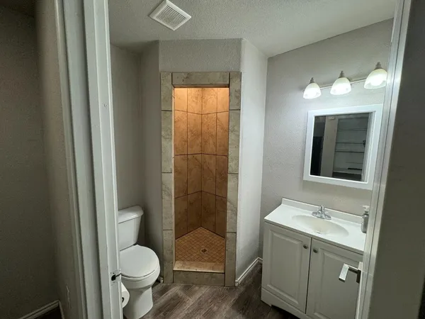 a bathroom with a toilet a sink and shower