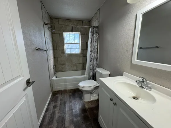 a bathroom with a sink toilet tub and shower