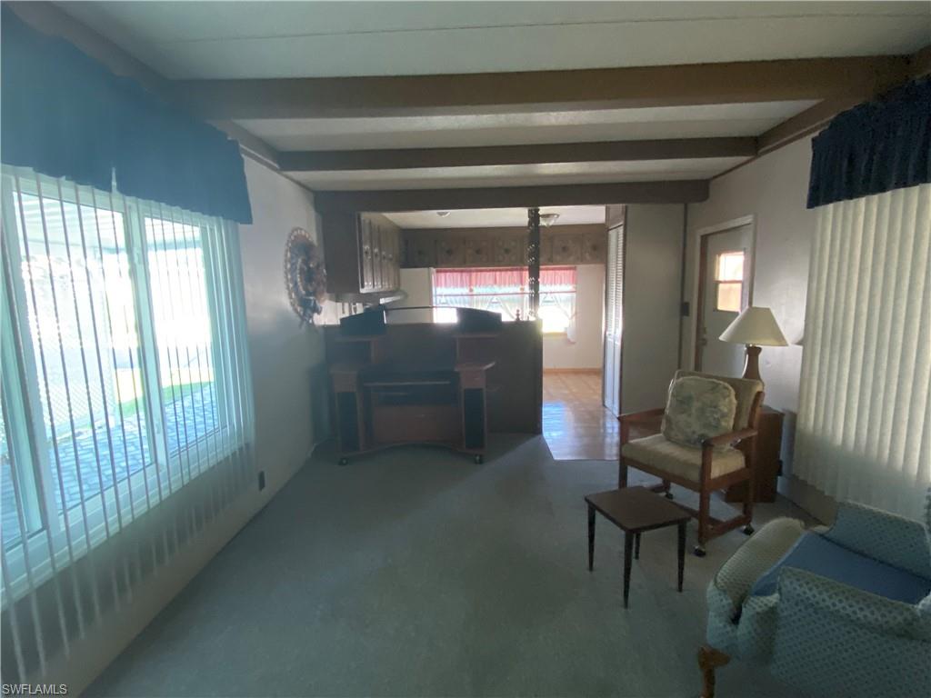 26 Cheyenne Trail, Unit 168 Naples, FL 34113 - Photo 14 of 21 a living room with furniture and a window