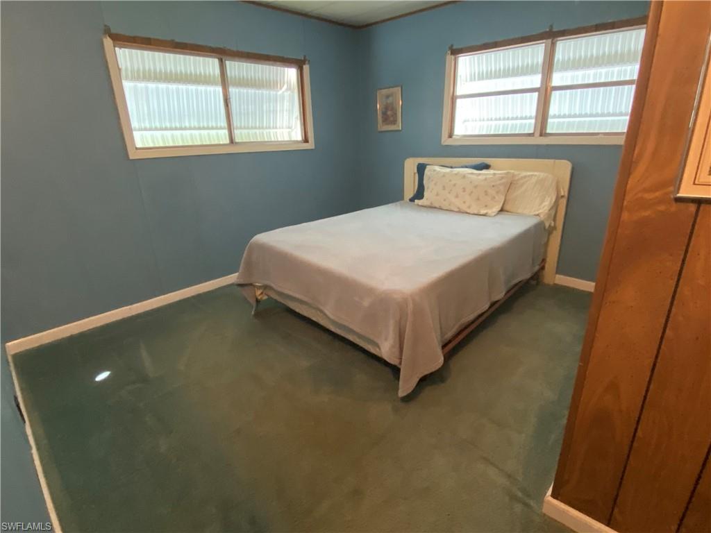 26 Cheyenne Trail, Unit 168 Naples, FL 34113 - Photo 16 of 21 a bed sitting in a bedroom next to a window