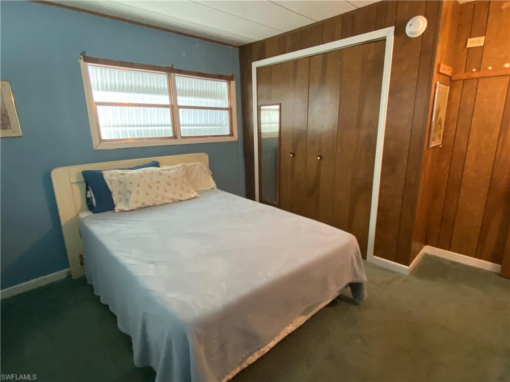 26 Cheyenne Trail, Unit 168 Naples, FL 34113 - Photo 17 of 21 a large bed sitting in a bedroom next to a window