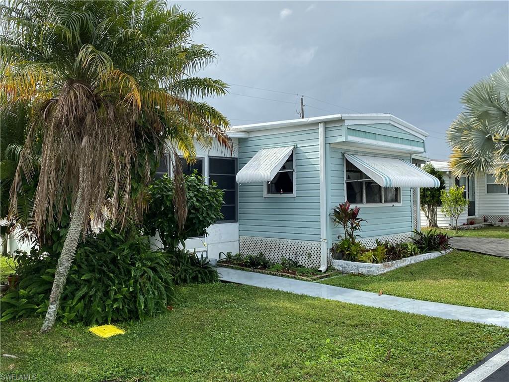 26 Cheyenne Trail, Unit 168 Naples, FL 34113 - Photo 2 of 21 a front view of house with yard and green space
