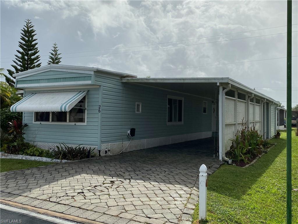 26 Cheyenne Trail, Unit 168 Naples, FL 34113 - Photo 3 of 21 a front view of a house with garden