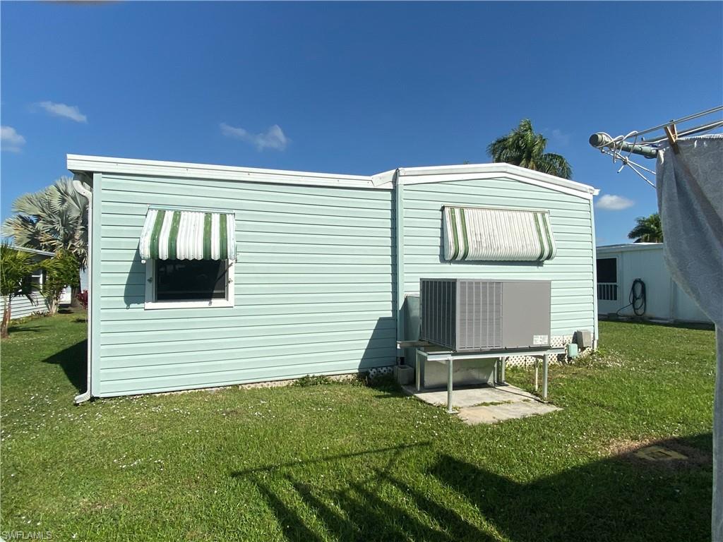 26 Cheyenne Trail, Unit 168 Naples, FL 34113 - Photo 4 of 21 a front view of a house with a yard