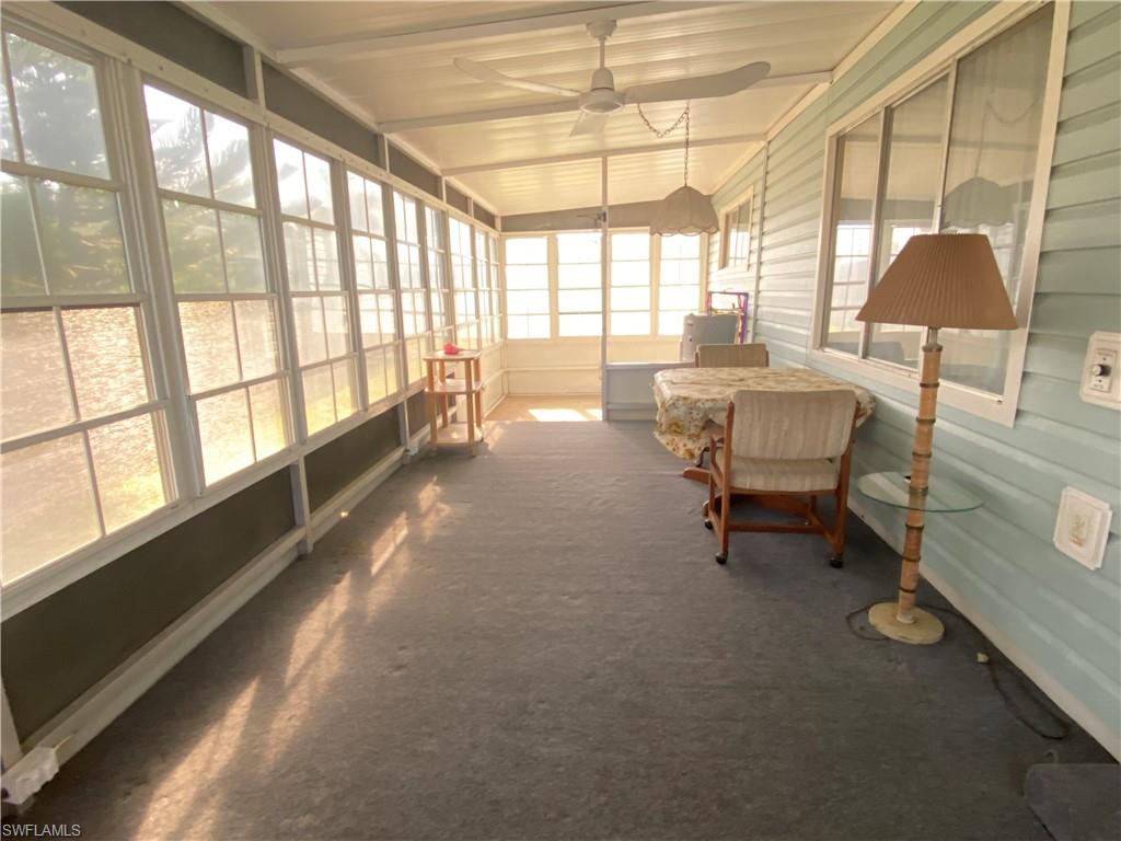 26 Cheyenne Trail, Unit 168 Naples, FL 34113 - Photo 8 of 21 a dining room with furniture and a floor to ceiling window