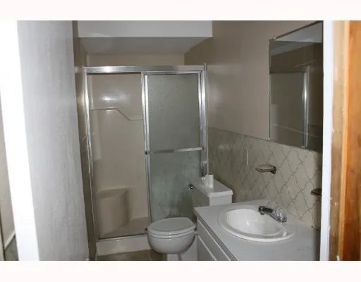 a bathroom with a shower a toilet and a sink