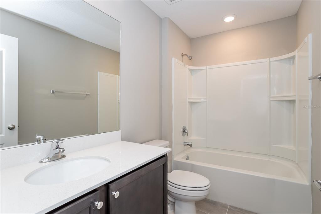 349 Daffodil Lane Kissimmee, FL 34759 - Photo 13 of 16 a bathroom with a sink a toilet and shower
