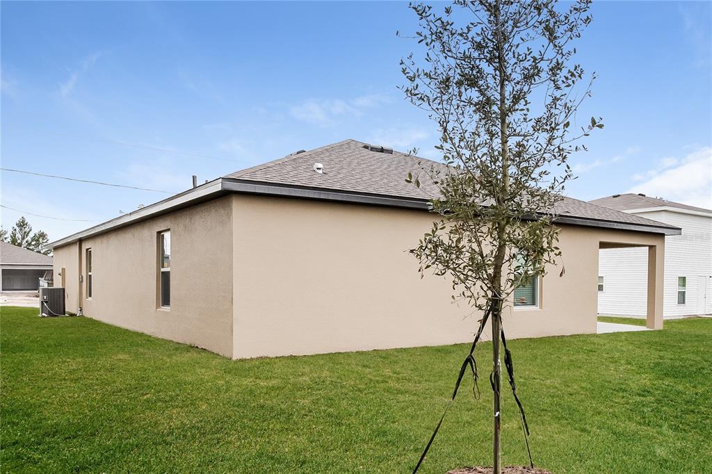 349 Daffodil Lane Kissimmee, FL 34759 - Photo 15 of 16 a front view of a house with a garden