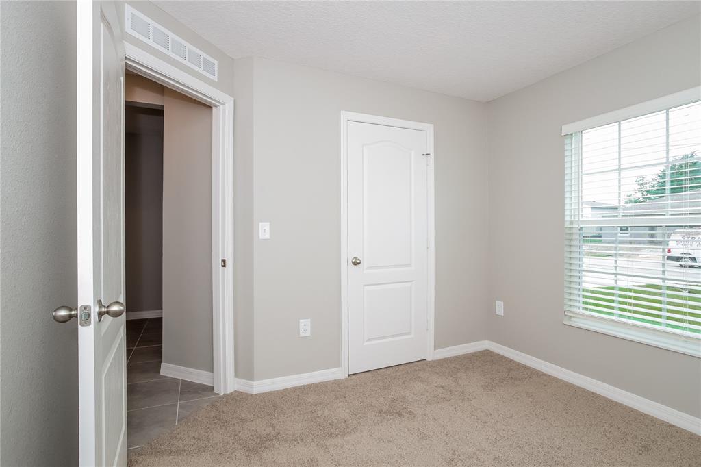 349 Daffodil Lane Kissimmee, FL 34759 - Photo 8 of 16 an empty room that has a window in it