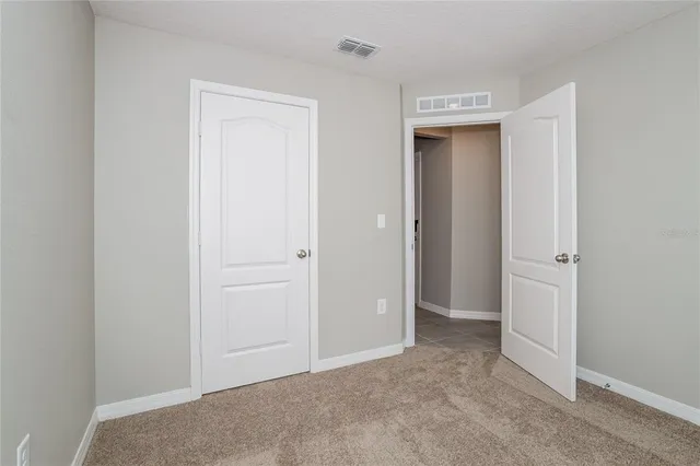 a view of an empty room and closet area