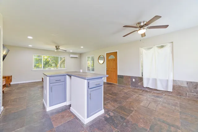 a bathroom with a bathtub shower sink vanity mirror and toilet
