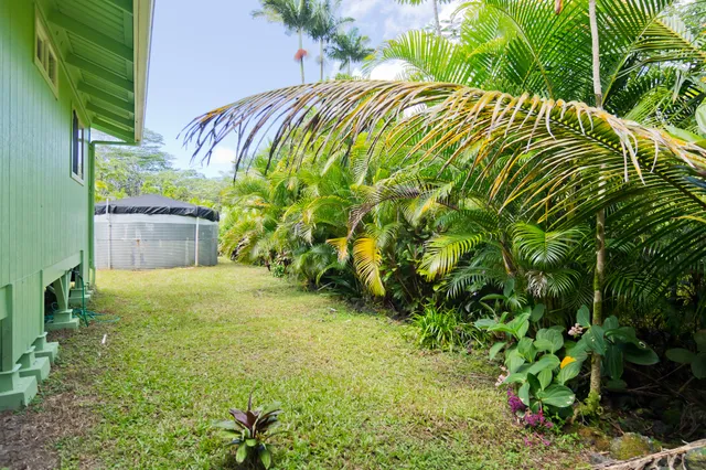 a backyard of a house with table and chairs