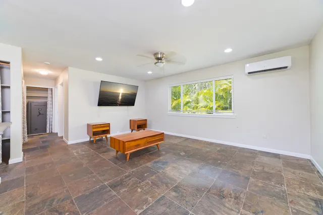 a view of a livingroom with a flat screen tv and couches