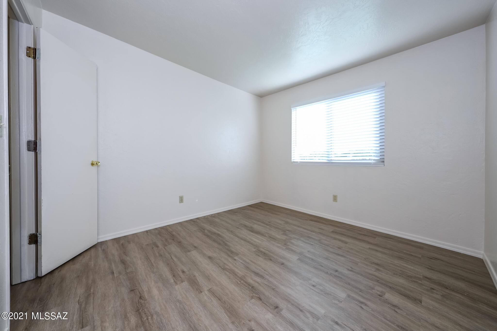 312 East 24th Street, Unit 4 Tucson, AZ 85713 - Photo 8 of 17 an empty room with wooden floor and windows