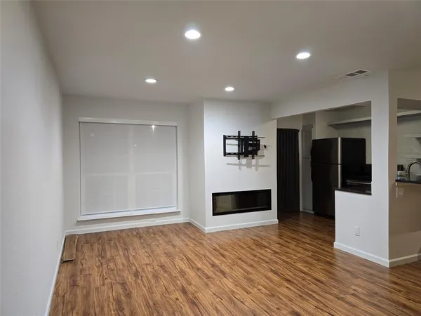 a kitchen with a refrigerator and a stove top oven