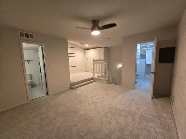 a view of walk in closet with empty racks