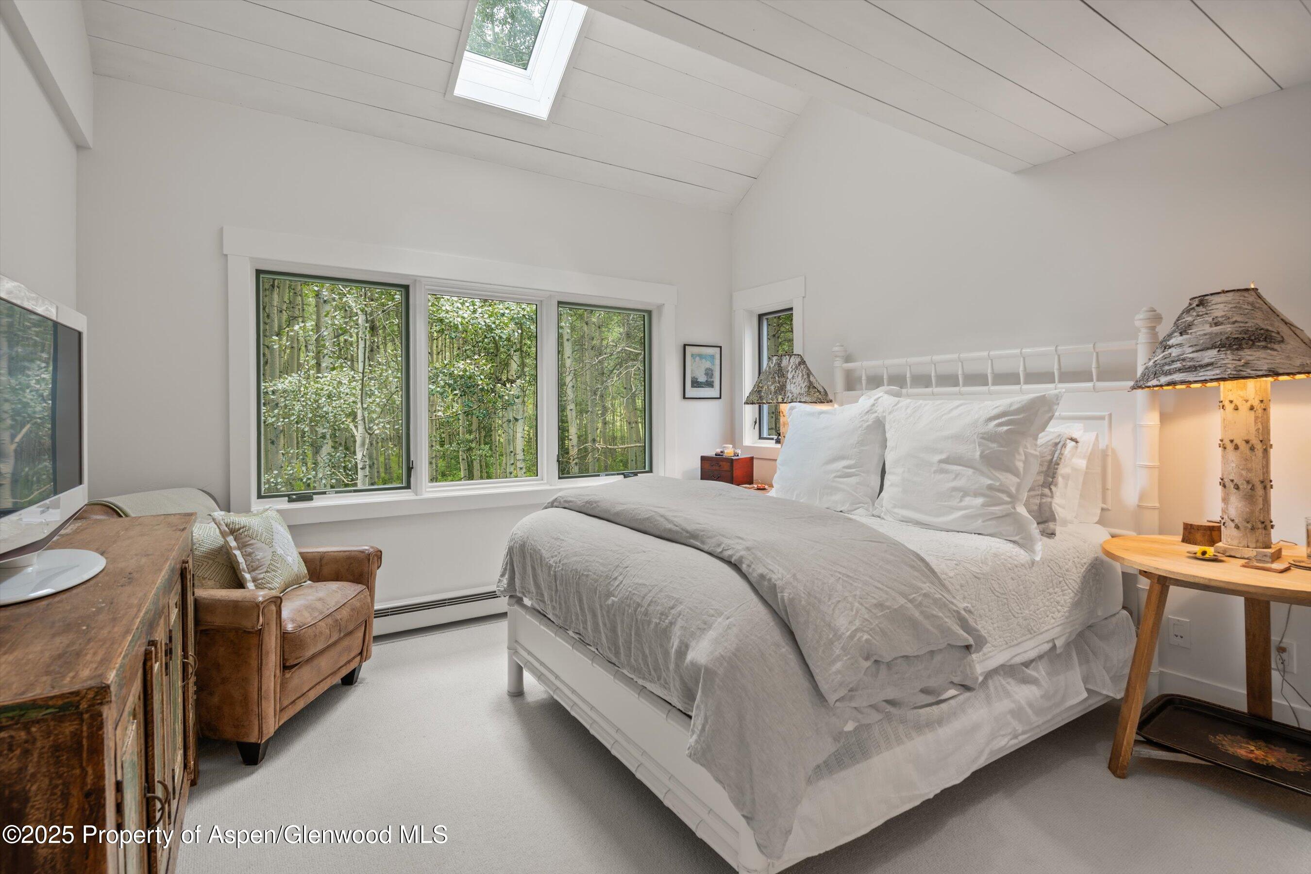9555 Castle Creek Road Aspen, CO 81612 - Photo 29 of 42 a bedroom with a bed and a large window