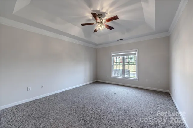 a view of room with window and ceiling fan