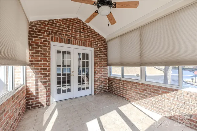 a view of a porch with a table and chairs