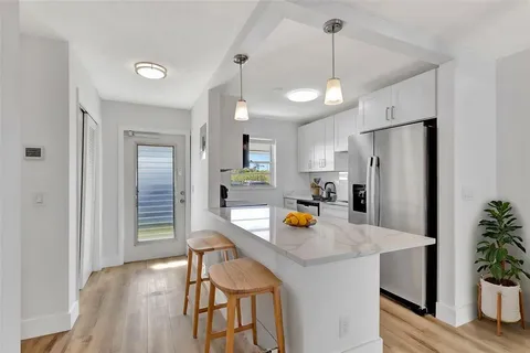 a view of a kitchen and a sink dishwasher with wooden floor