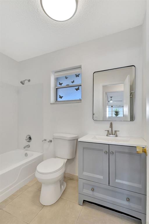 300 Southwest Golfview Terrace, Unit 131 Boynton Beach, FL 33426 - Photo 20 of 57 a bathroom with a toilet sink and mirror