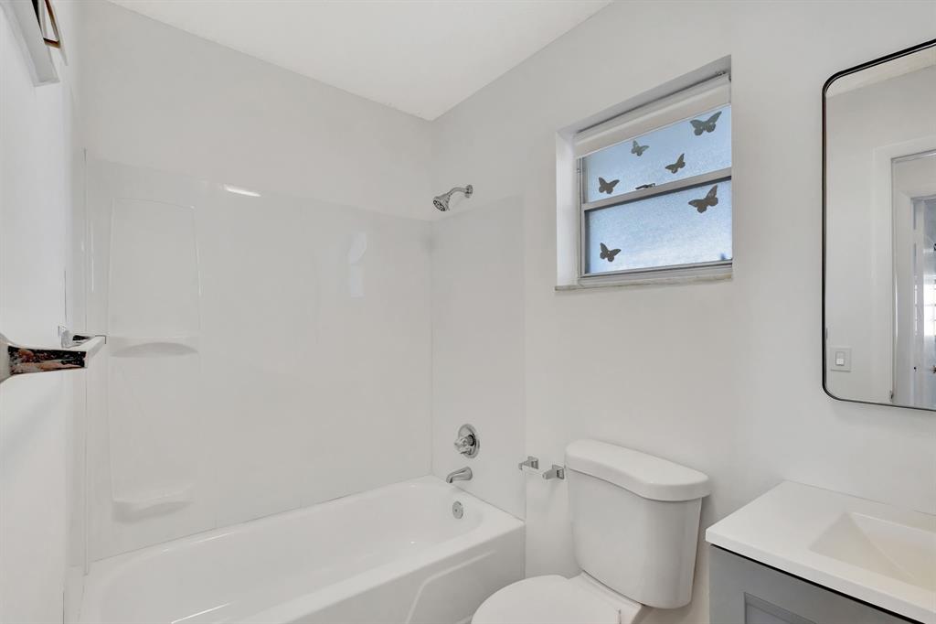 300 Southwest Golfview Terrace, Unit 131 Boynton Beach, FL 33426 - Photo 21 of 57 a white toilet sitting next to a bath tub