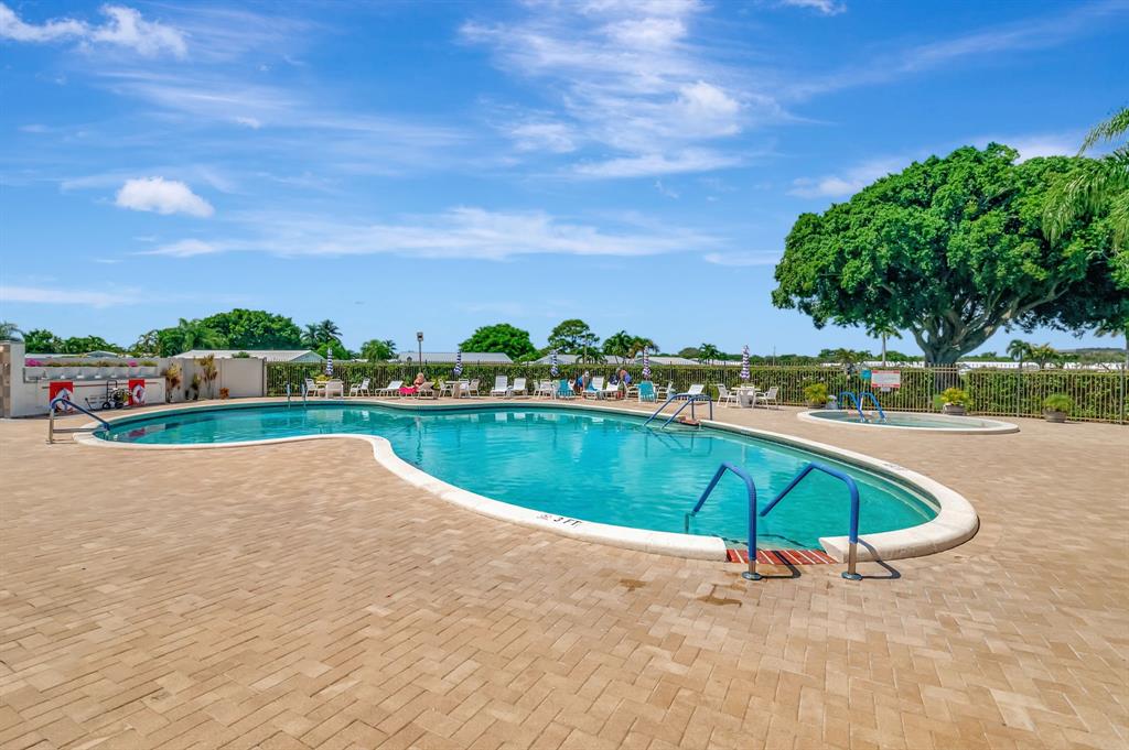 300 Southwest Golfview Terrace, Unit 131 Boynton Beach, FL 33426 - Photo 53 of 57 wooden view of outdoor space with swimming pool and green space