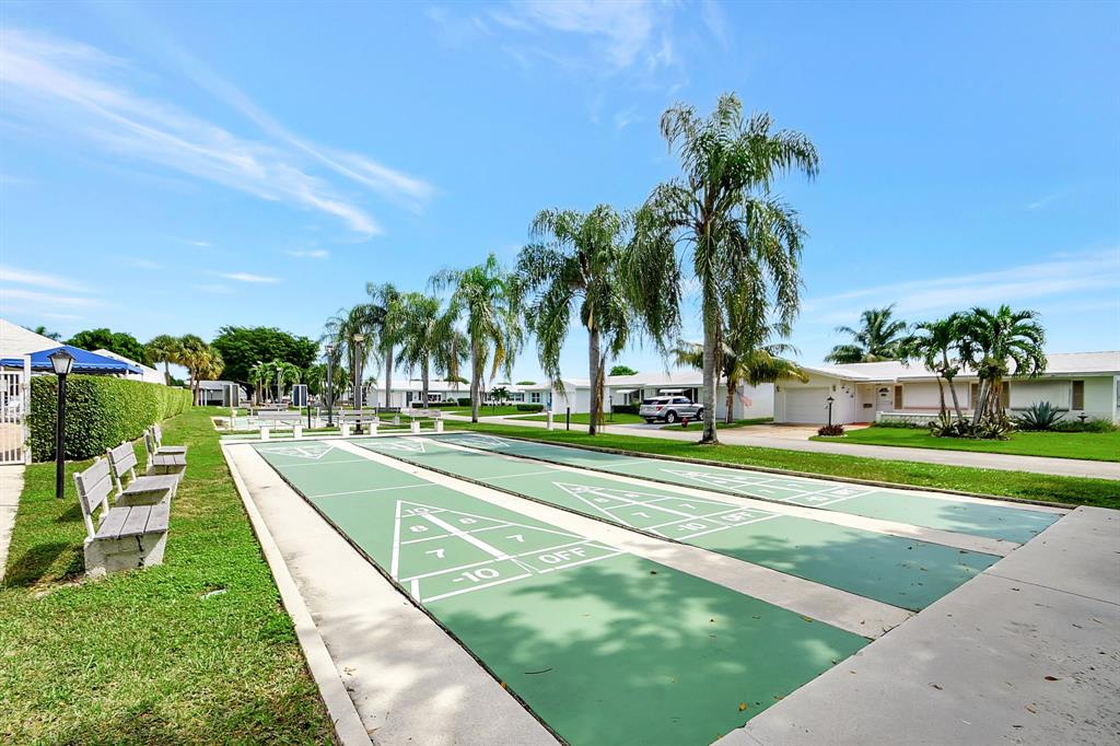 300 Southwest Golfview Terrace, Unit 131 Boynton Beach, FL 33426 - Photo 57 of 57 a view of a swimming pool with a lawn chairs and plants